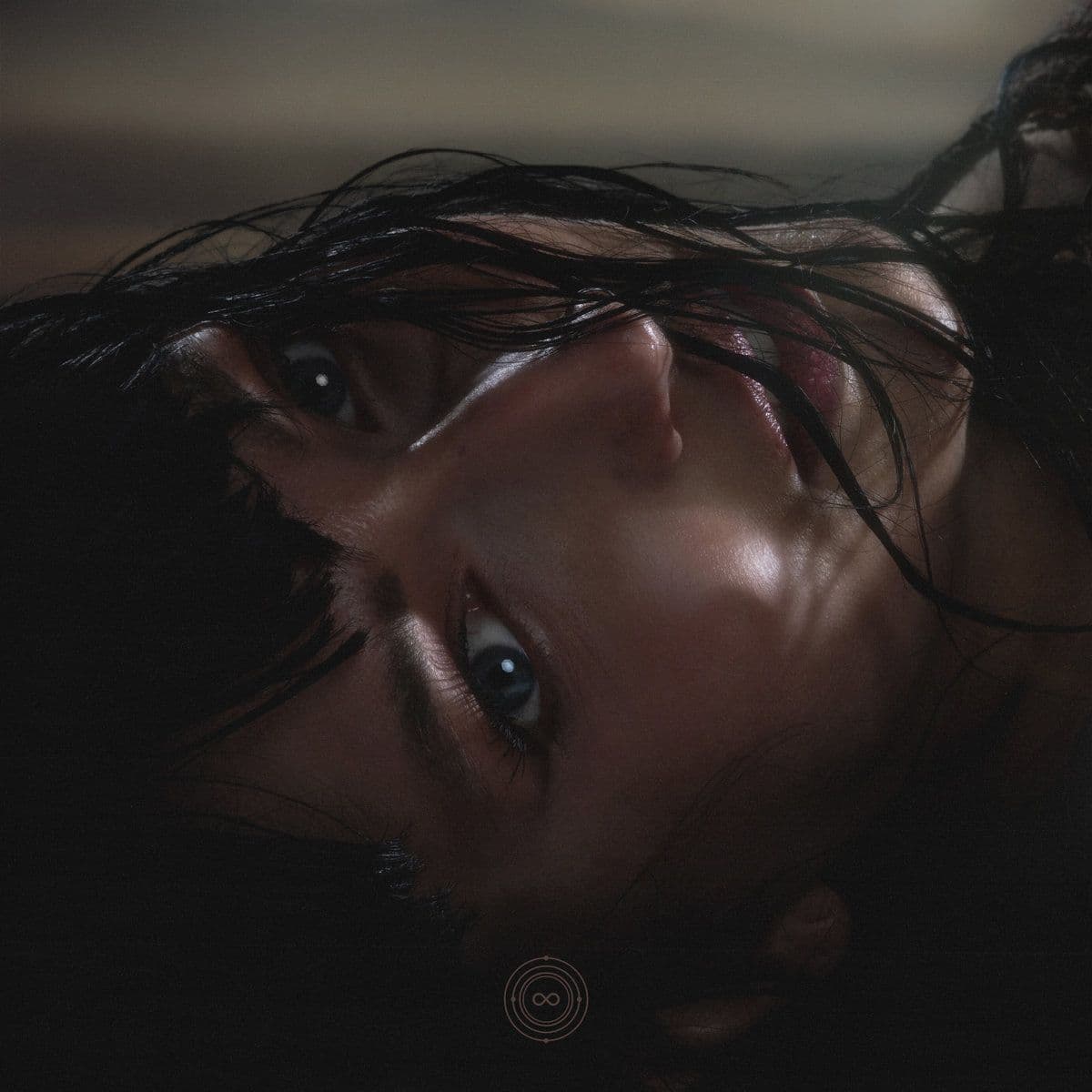 Close tilted portrait with wet dark hair across the face in low light