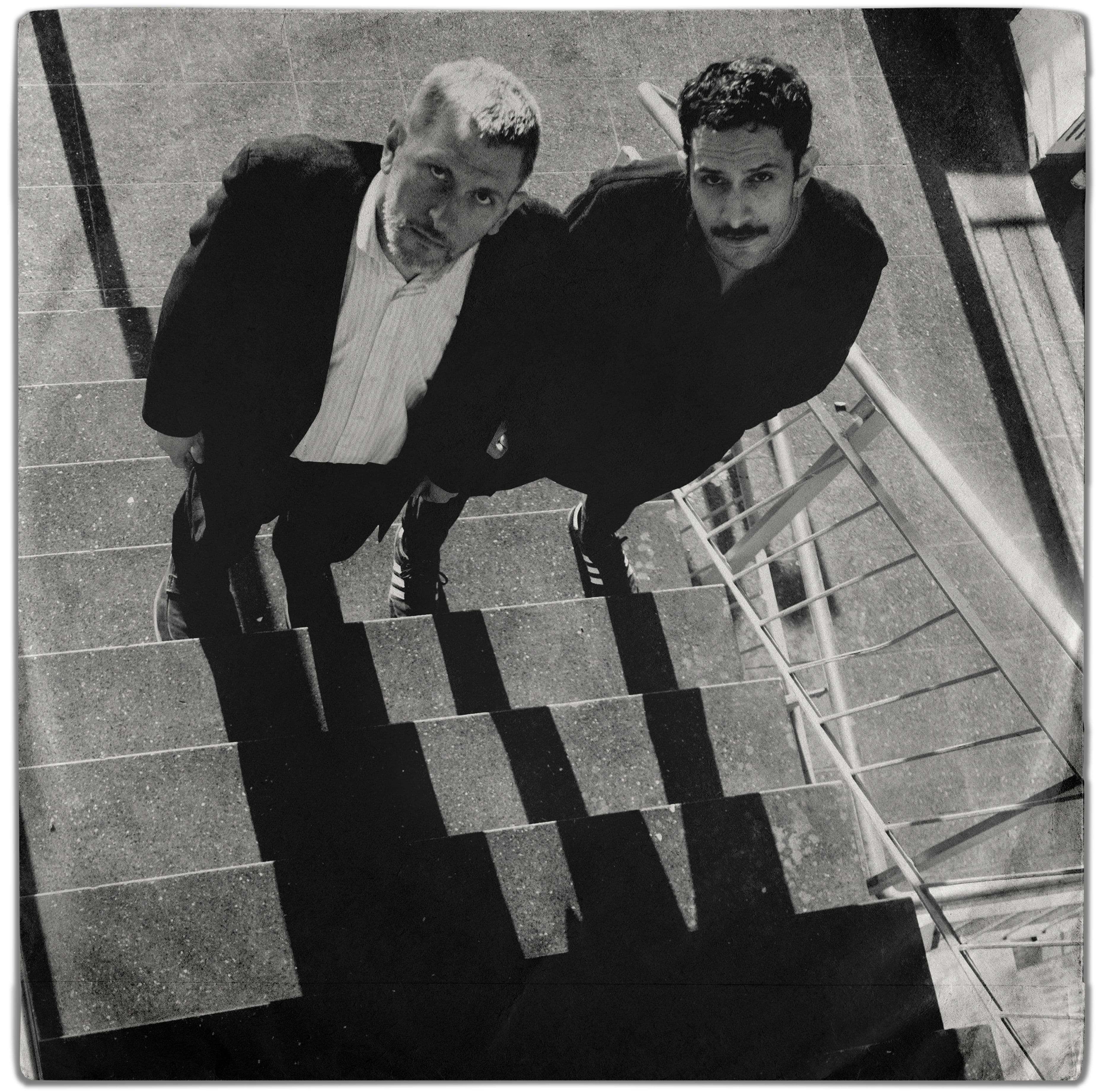 Black and white overhead portrait of two people on a staircase