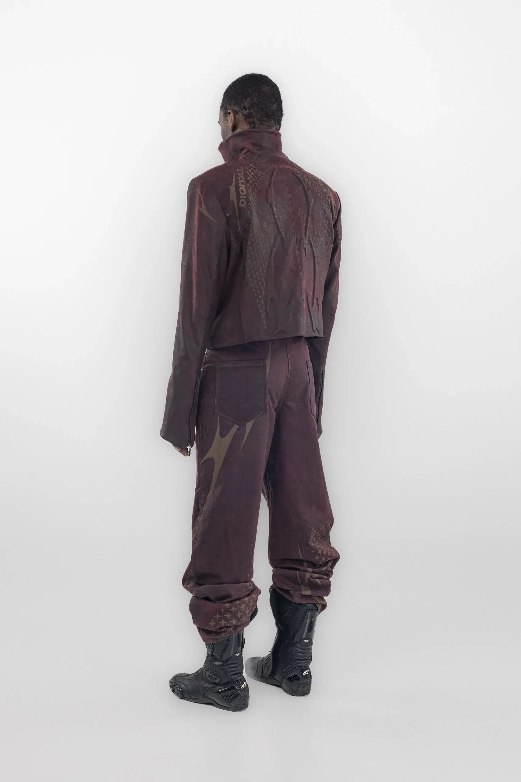 Rear view of a burgundy jacket and trousers with tonal curved graphics