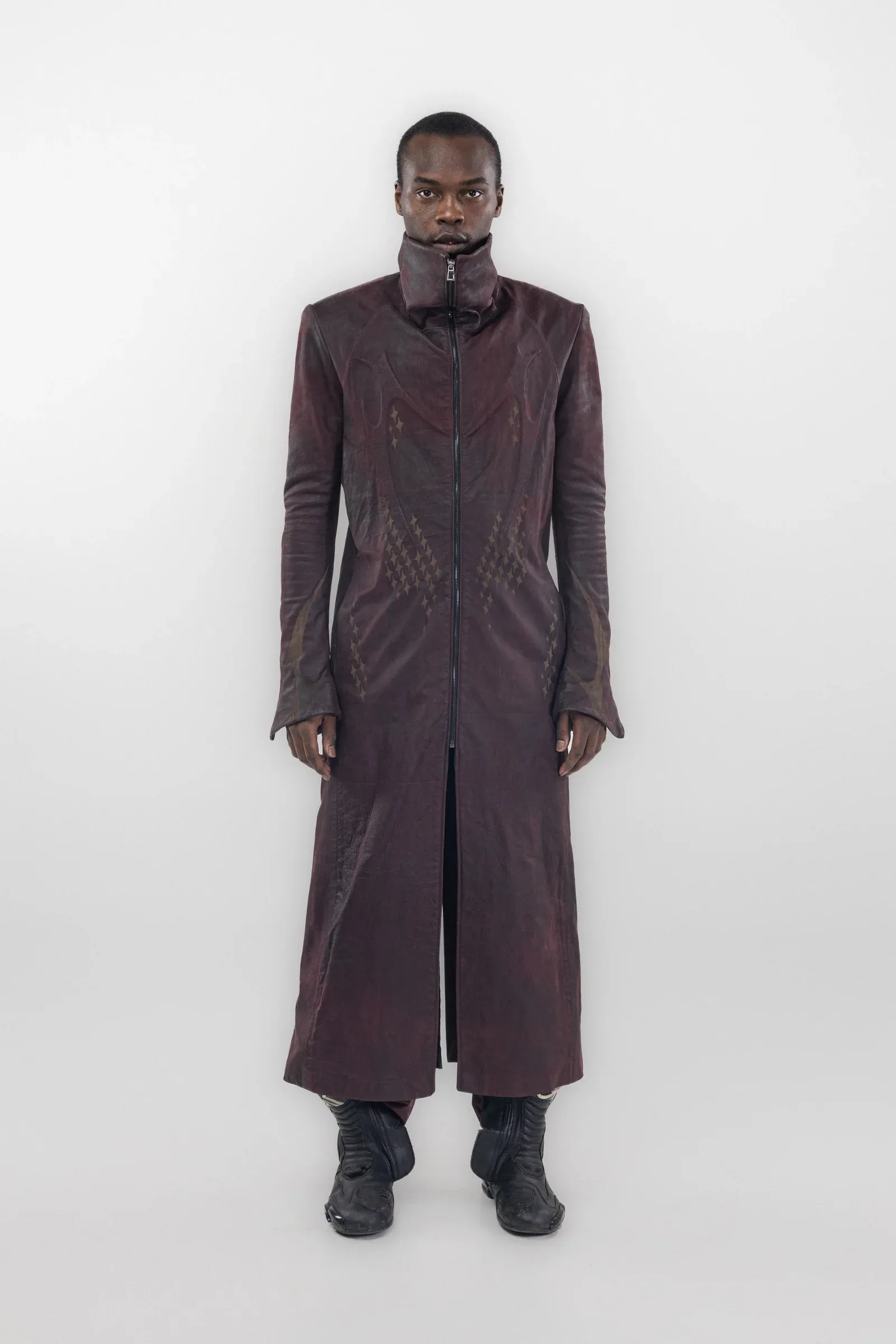 Front view of a long burgundy coat with dark curved graphics