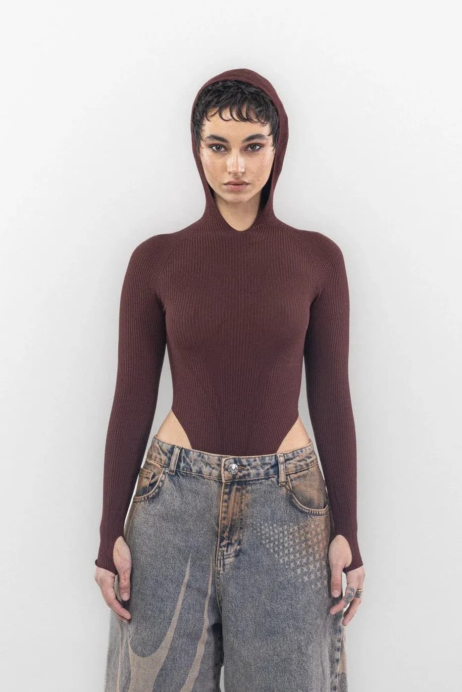 Front of a burgundy hooded bodysuit with side cutouts and long sleeves