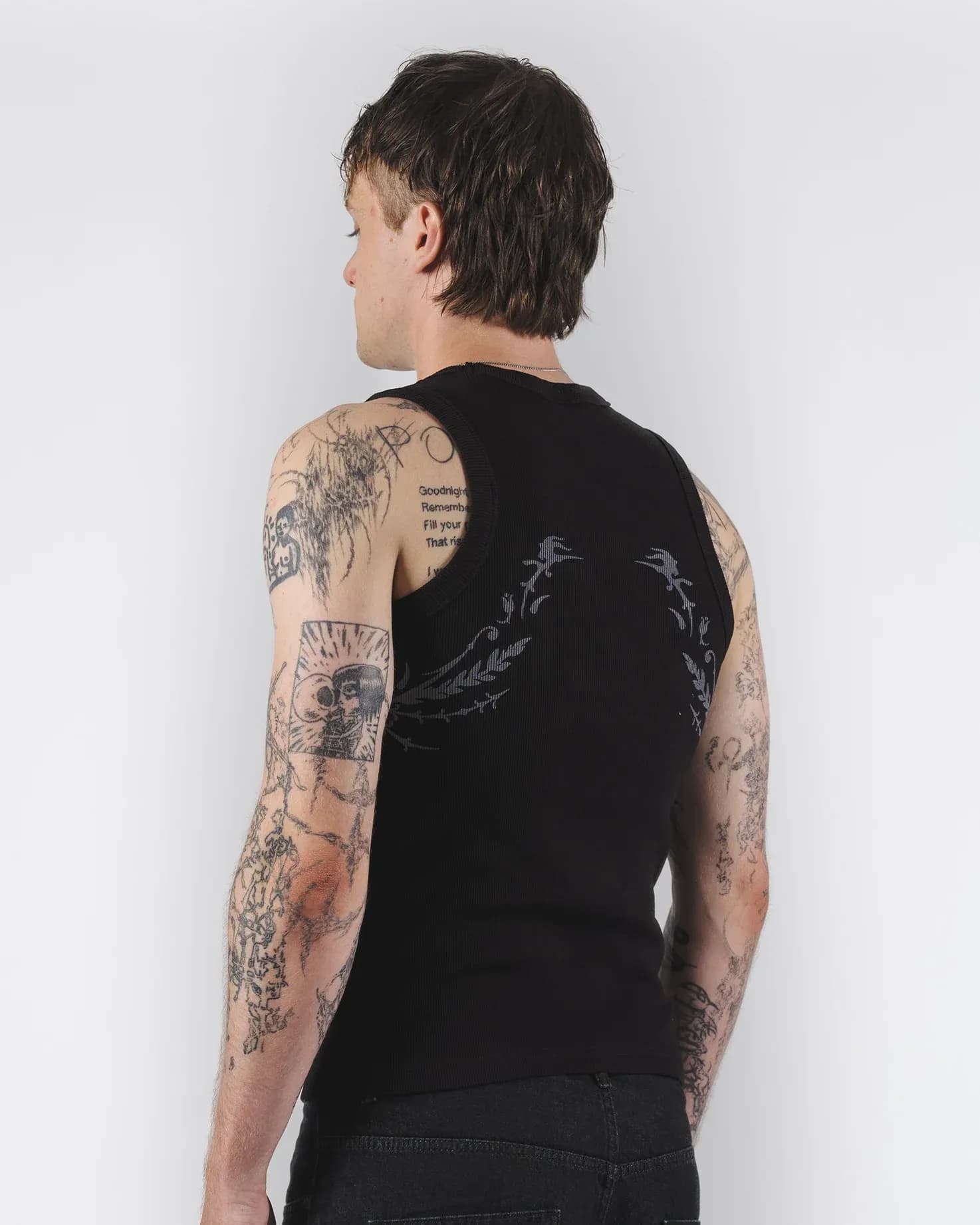 Rear view of a black tank top with curved pale graphics on the back
