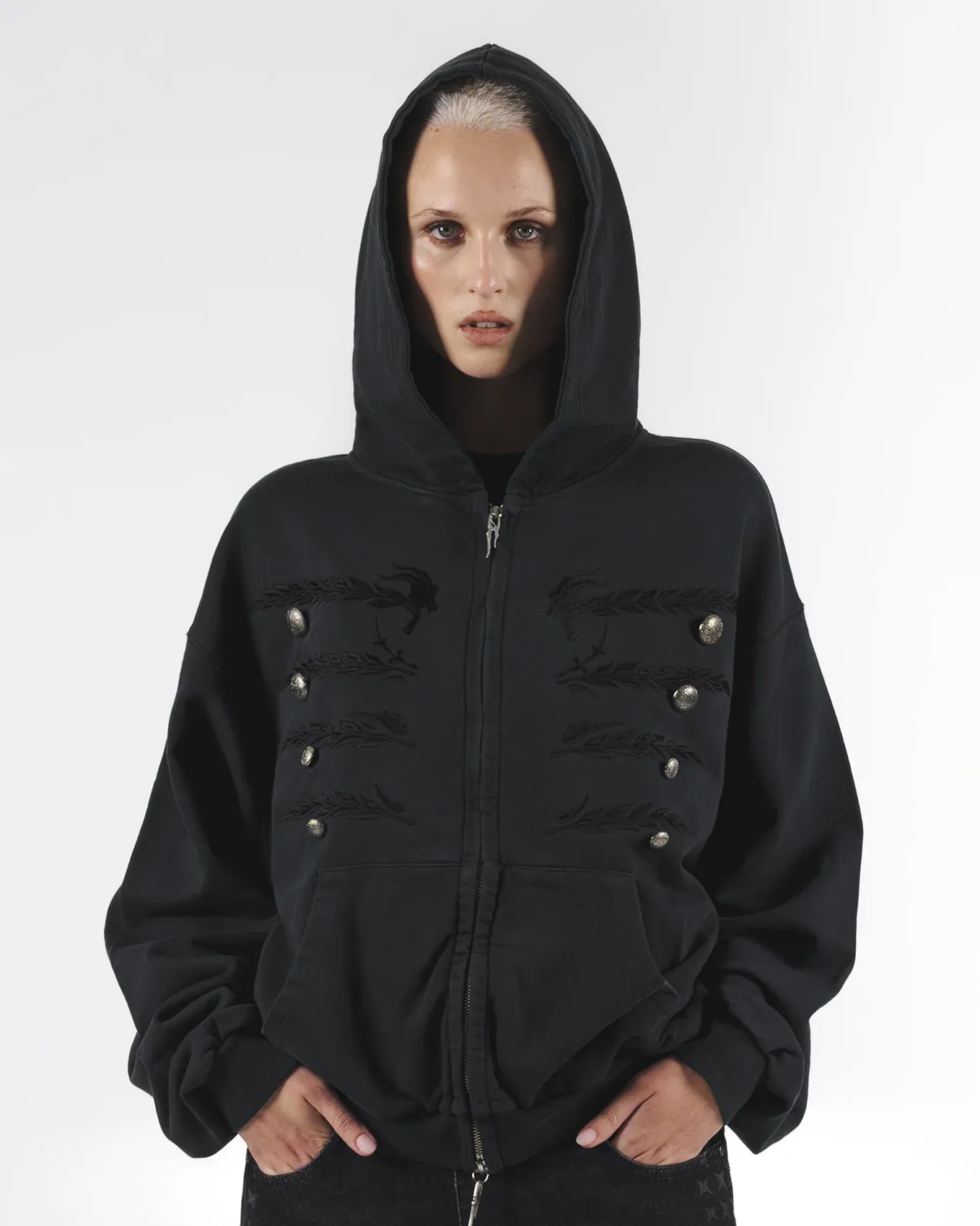 Front view of a black hooded zip jacket with rows of buttons and loop details